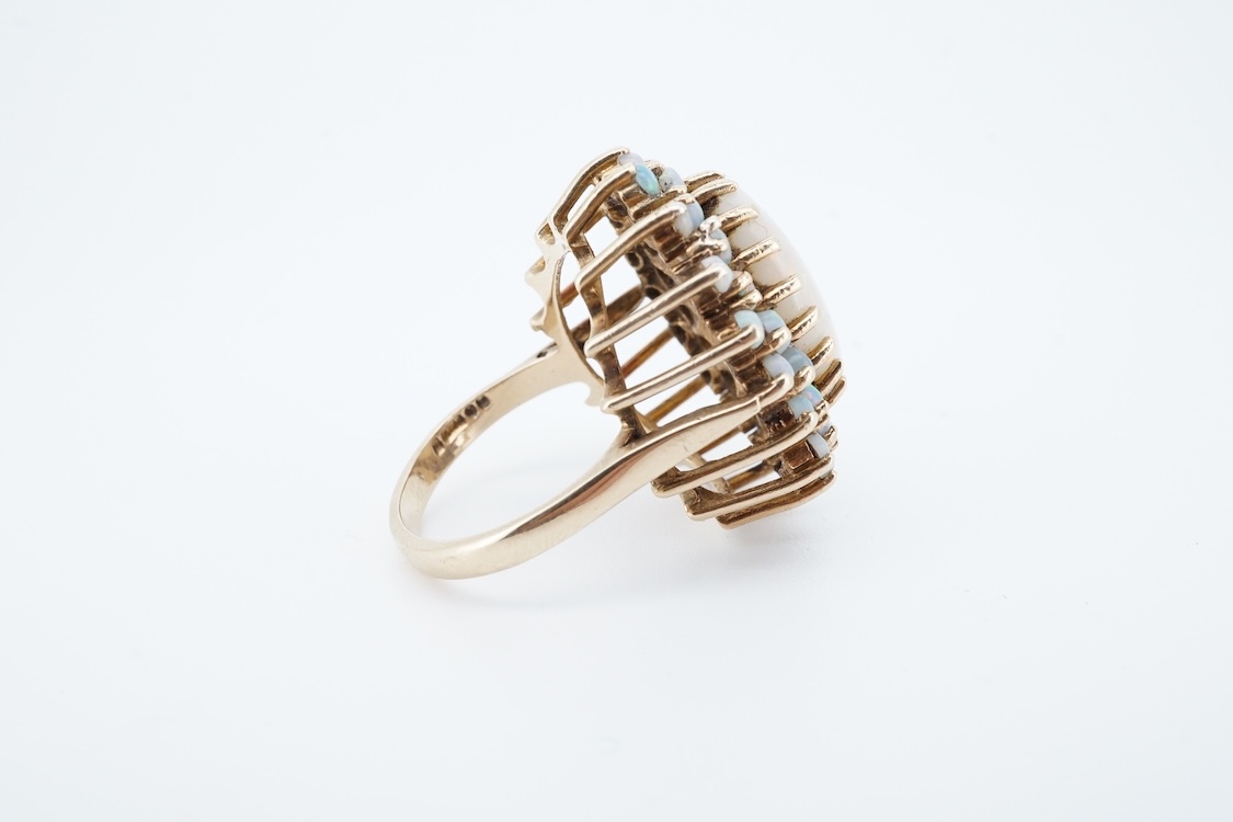 An early 1970's 9ct gold and opal cluster set dress ring, size O, gross weight 9 grams.